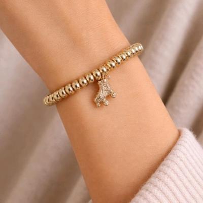 دستبند دخترانه مرواریدی طلایی با آویز اسکیت